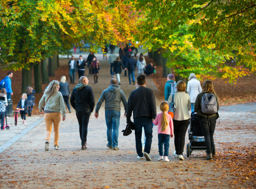 LONDON, UK – OCTOBER 31, 2015: Autumn in London park, people and families walking and enjoying the weather