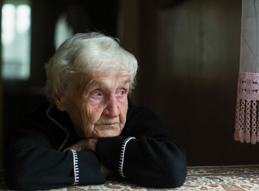 Portrait of sad elderly woman in the his house.