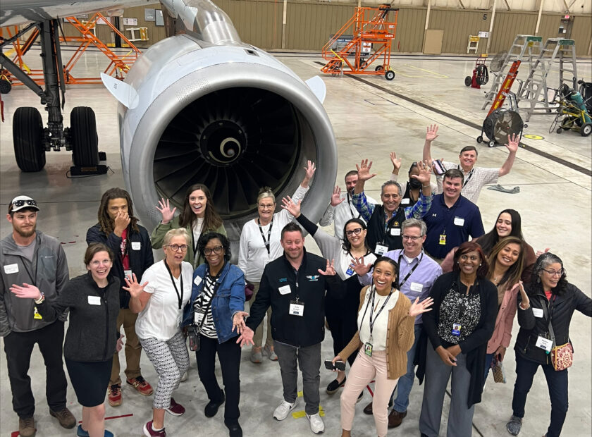 group of people in front of plan wing and engine