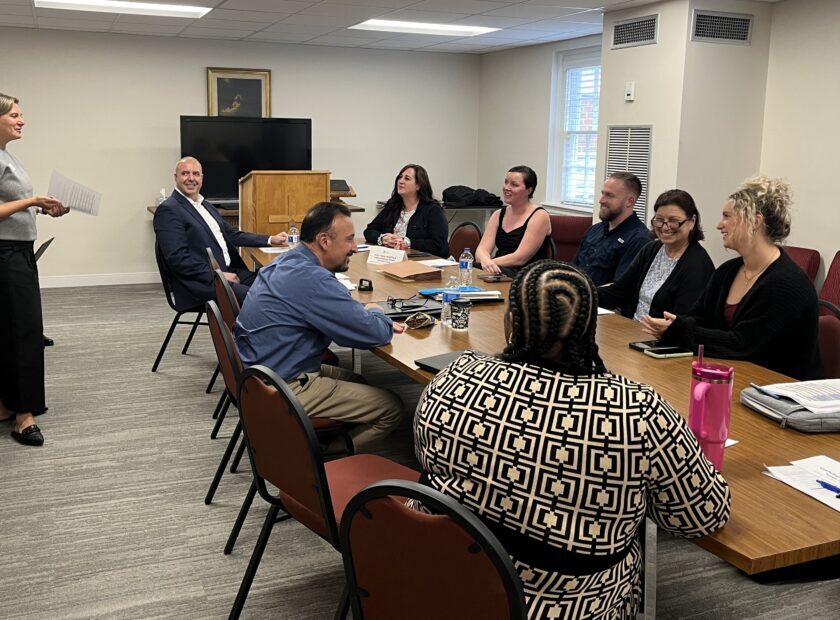 group of people meeting around a table