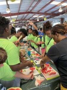 Children engaged in a learning exercise with watermelon