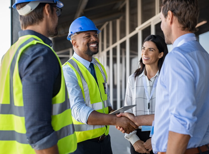 Engineer and businessman handshake at construction site