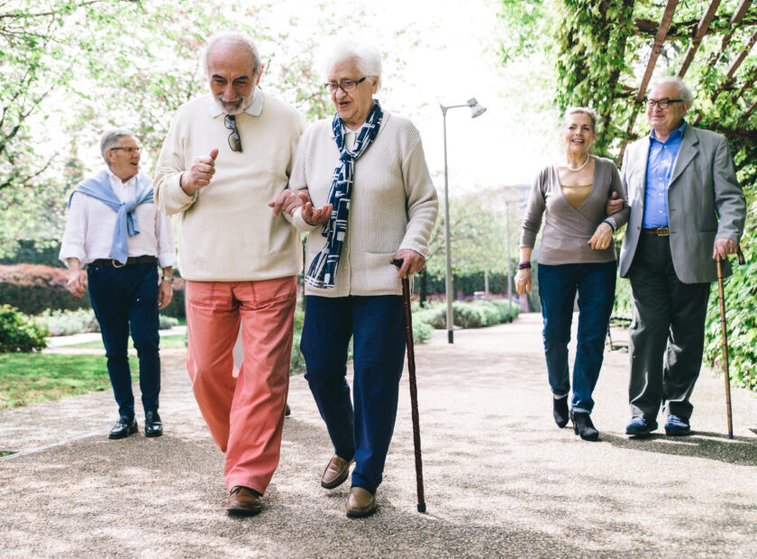 three older couples walking with canes