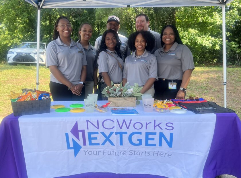 group of teenagers and young adults at an event booth