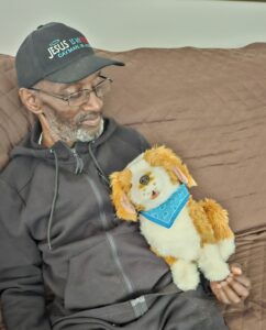 Man holding animatronic dog